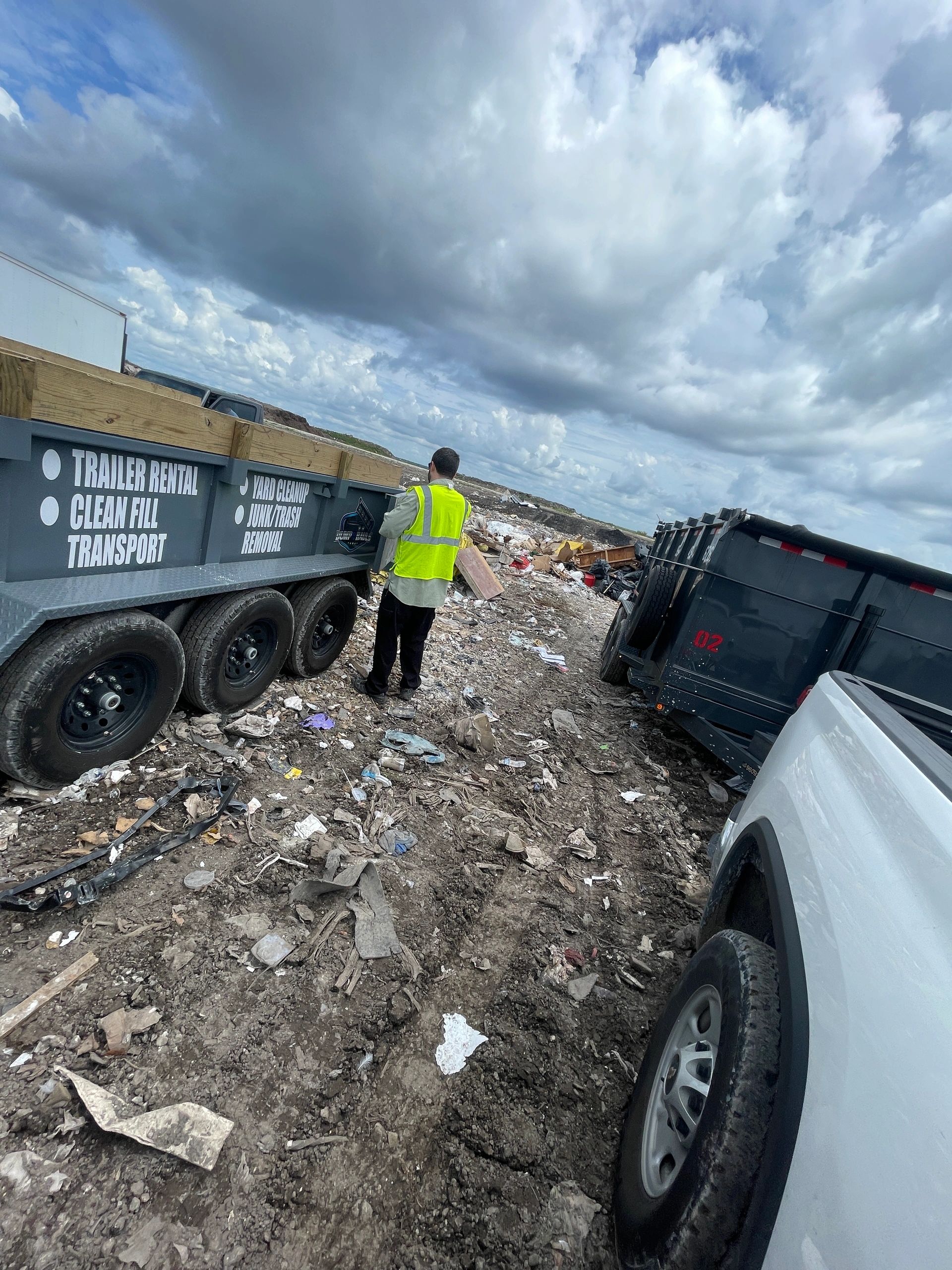 Worker at landfill waste disposal site